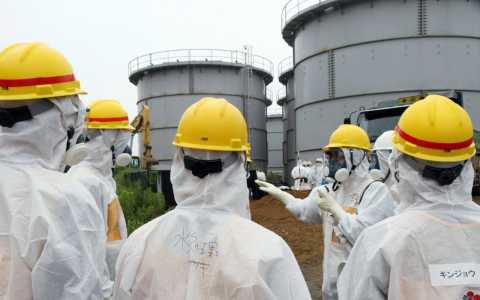 Workers at leaking water tanks at the Fukushima nuclear plant. Japan Pool/ AFP/ Getty Images