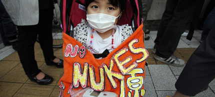 Kaede Tanaka, 3, sits in her buggy with a Geiger counter placed on her lap, during an anti-nuclear protest in front of the Japanese prime minister's official residence in Tokyo June 8, 2012. (photo: Reuters)